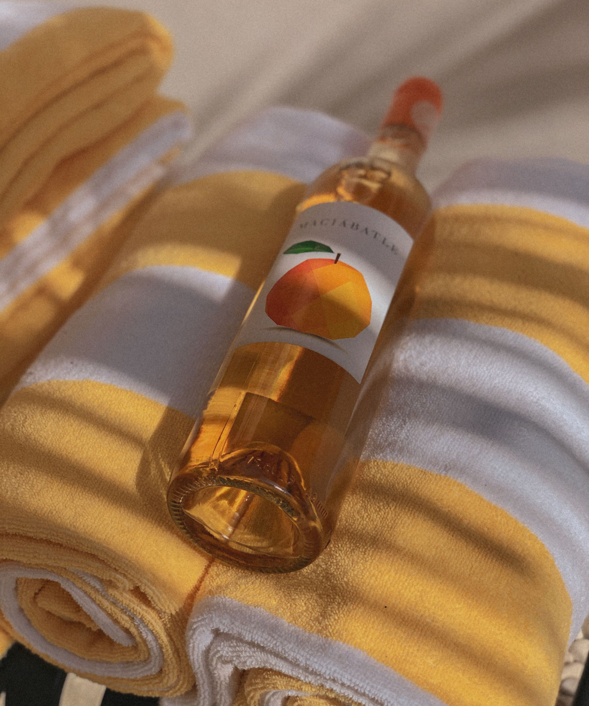 Orange wine on striped beach towel